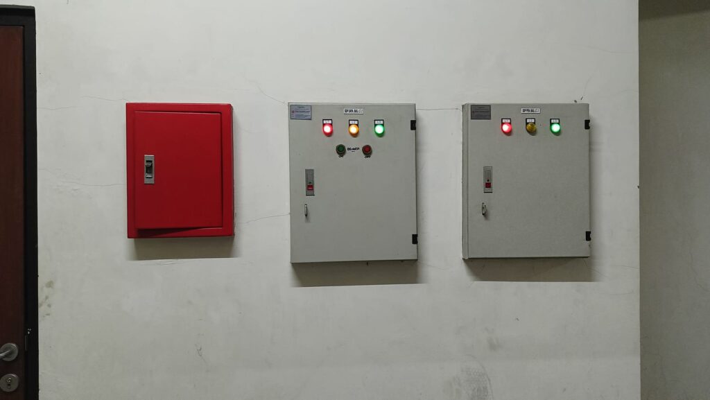 fire-safety-and-electrical-control-panels-on-white-wall