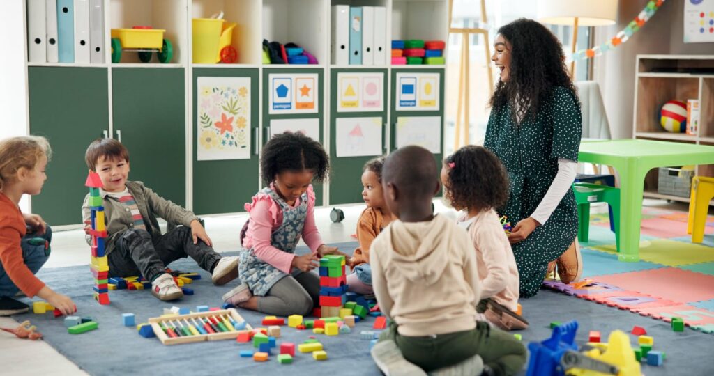 building-blocks-learning-and-teacher-with-children-in-classroom